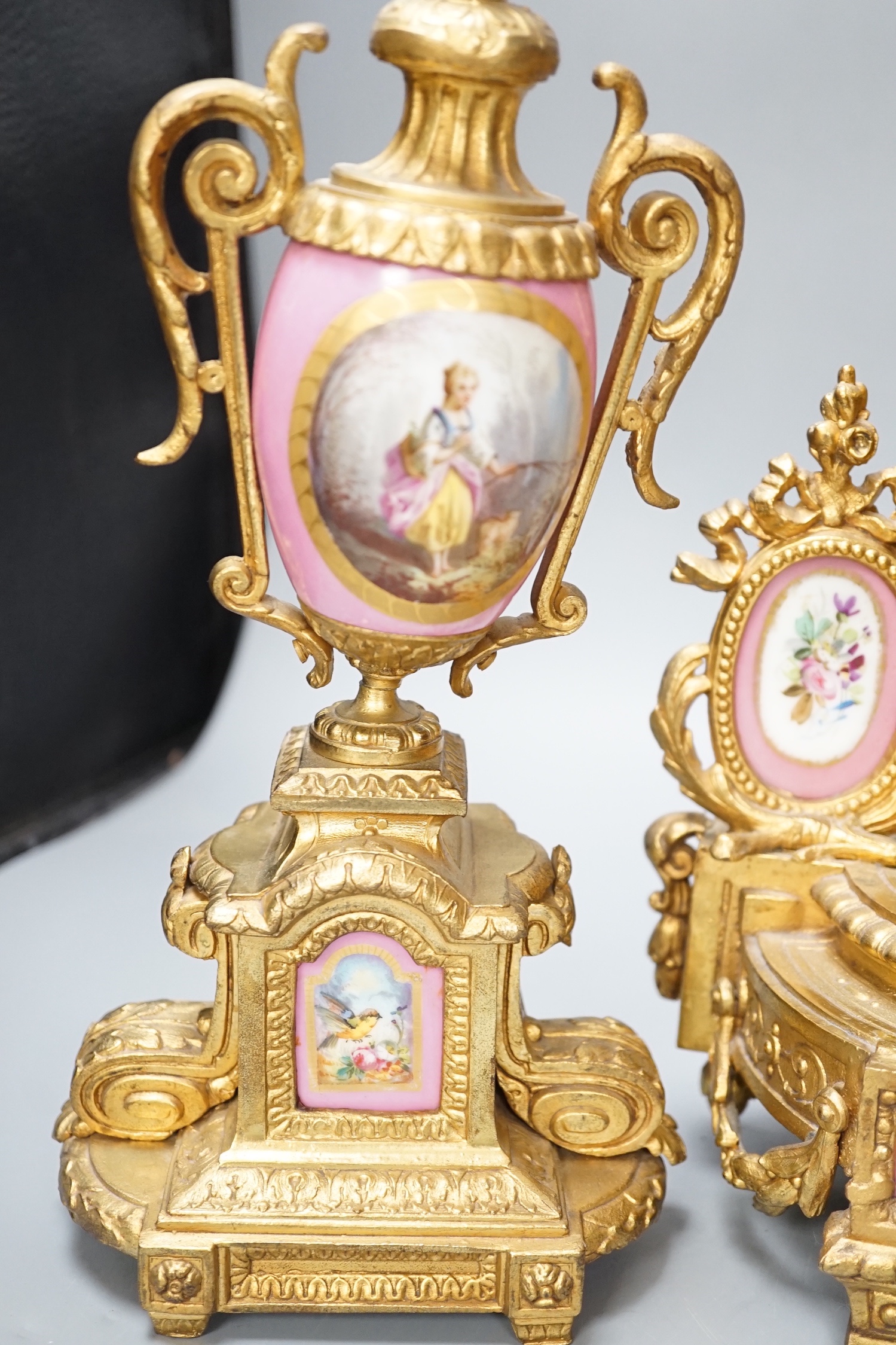 A French gilt metal and porcelain clock garniture. 36.5cm